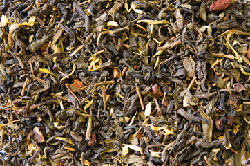 Green tea with additives closeup on white background. Proper nutrition, healthy tonic drink.