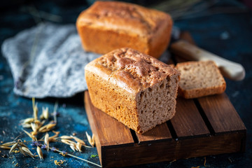 Fototapeta na wymiar Sourdough bread. Sliced rye bread on a dark background. Healthy eating concept.