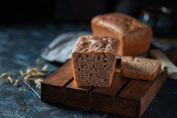 Sourdough bread. Sliced rye bread on a dark background. Healthy eating concept.