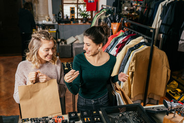 Beautiful young women is smiling while choosing ring in the shopping mall