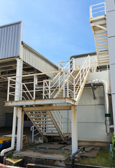Naklejka premium Iron staircase for up to maintenance work. Steel stairs are on the side of the building