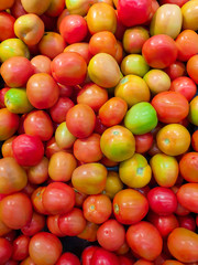 Pile fresh tomatoes in market.Fresh tomatoes as a background.