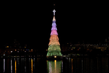 Floating Christmas tree on the city lake of Rio de Janeiro with colours of the rainbow showing acceptance of the LGBTQ community in Brazilian society