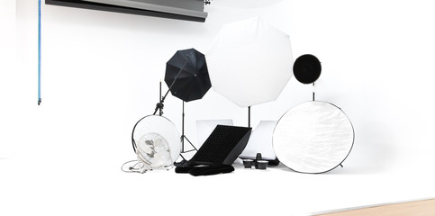 modern photo professional lighting equipment. Octabox, softbox, beauty dish and studio background 