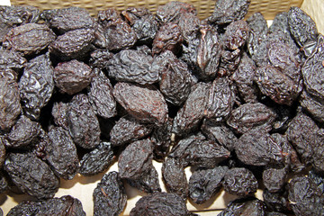 Dried plums or prunes. Dark prunes background. Dry fruit pattern.