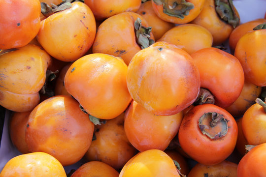 Ripe organic persimmon fruit. Persimmon pattern.