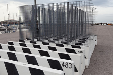 Road blocks with painted numbers and fences