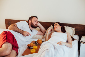 husband and wife wake up in the morning in the bedroom weekend breakfast in bed