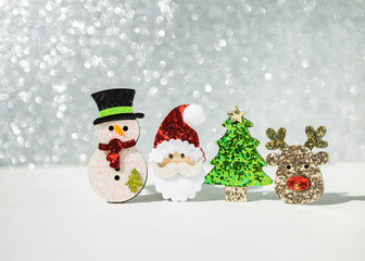 Christmas concept background, snowman with Santa and reindeer over blurred shiny silver bokeh background, Christmas decorate item