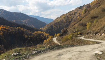 The mountain  road runs between the mountains in Svaneti in the mountainous part of Georgia