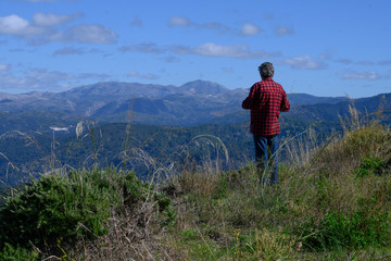 Rear view of man looking at view, Algatocin, Malaga, Andalusia, Spain