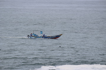 Naklejka premium A Fishing Boat Sailing for Fish in the Middle of The Sea