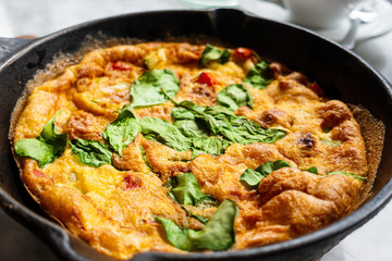 Delicious homemade omelet with vegetables cooked in oven and served in a traditional pan