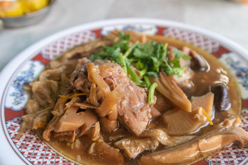 close up of Bak Kut Teh, stew of pork and herbal soup on bowl