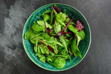 Healthy salad, leaves mix (mix micro greens, arugula, onion, other ingredients). food background. copy space