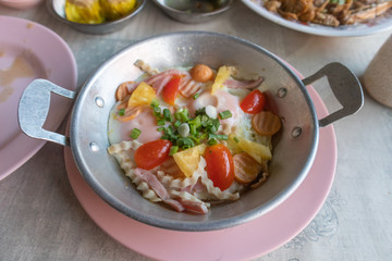 eggs fired pan with topping, famous breakfast Thai style in Thai restaurant