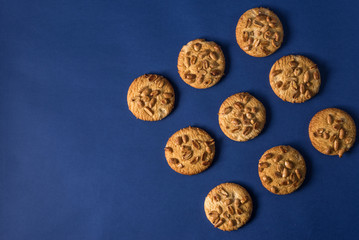  homemade healthy cookies with roasted peanuts on a blue background with place for your text