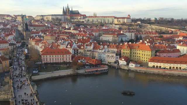 Aerial view of Charles Bridge and Prague Castle at sunset light in desember in Prague, Czech Republic