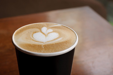 cup of hot latte coffee with beautiful heart-shaped pattern on top for decoration, latte art on coffee cup, shallow depth of field