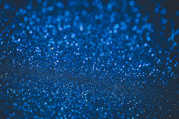 Blue abstract bokeh background. Blue Christmas texture. Defocused shiny sequins.
