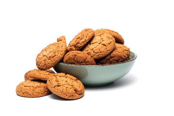 fresh tasty oatmeal cookies in a turquoise plate on a white background
