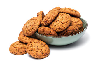fresh tasty oatmeal cookies in a turquoise plate on a white background