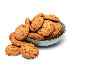 fresh tasty oatmeal cookies in a turquoise plate on a white background
