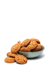 fresh tasty oatmeal cookies in a turquoise plate on a white background
