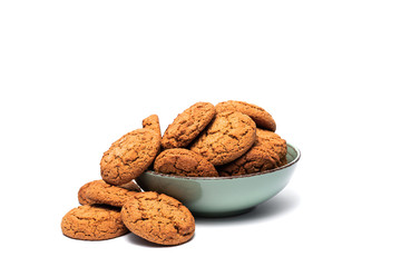 fresh tasty oatmeal cookies in a turquoise plate on a white background