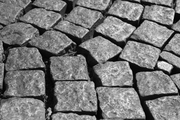 Cobblestone pavement close up background texture in black and white