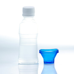 Bottle of eye solution with cup