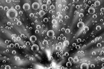 Oxygen Bubbles in Liquid. Rays. Background black and white.
