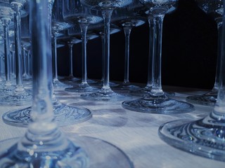  close-up of glassware in classic blue color with bokeh effect, decorative and festive glasses of different shapes and sizes