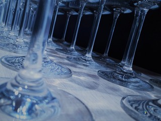  close-up of glassware in classic blue color with bokeh effect, decorative and festive glasses of different shapes and sizes