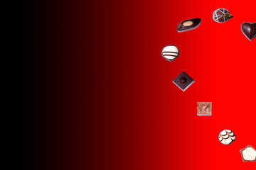 heart of chocolates over red background