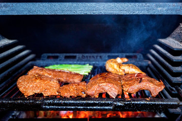 Grilling pork ribs in stove close up