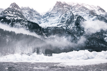 Fototapeta na wymiar Fog Coming Over The Snow Mountains, Switzerland.