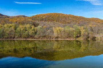 Fototapeta na wymiar Beautiful autumn landscape with peaceful lake in North Caucasus