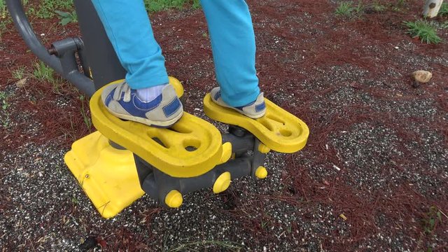 Akyaka, Mugla, Turkey - 10th of November 2019: 4K Boy's legs work out on step machine outdoors