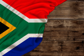 national flag of modern state of South Africa, beautiful silk, old wood background, concept of...