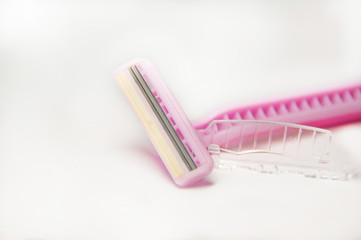  Disposable razor. Pink razor on a white background.