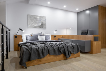Stylish bedroom with wooden furniture