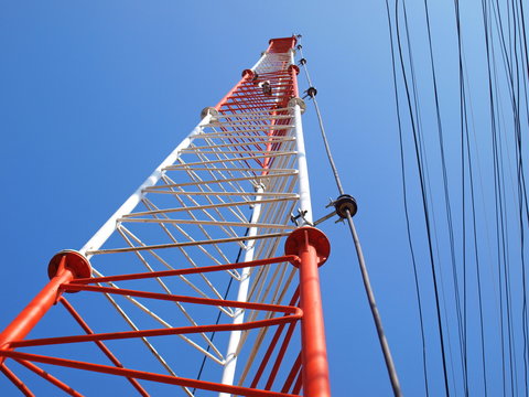 Lightning rod or ground wire on the tower Installed on the radio communication pole structure On the blue sky background and cable