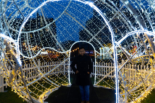 Rahul Mandal Smiling Inside Christmas Light Structure Middle