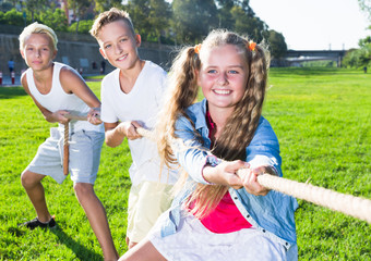Children playing tug of war outdoors