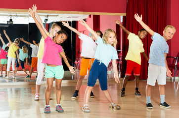 Boys and girls having dancing class in studio