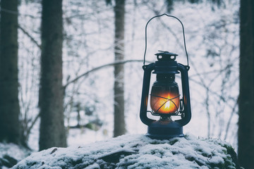 Beautiful colorful illuminated lamp in the forest. Retro style lantern at night outdoor.  © raland