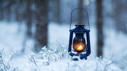 Mystical scene with old kerosene lamp in snow. Fairy abstract scene. Magic vintage lantern lighting. Copy space © raland
