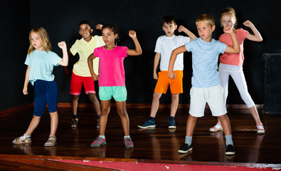Children studying modern style dance in class
