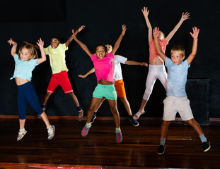 Children jumping while studying modern style dance